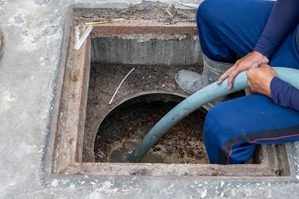 specialized vacuum trucks are used for grease trap pumping, equipped with hoses and pumps to efficiently remove the grease and solids